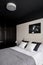 Bedroom with black ceiling and wardrobe