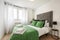 Bedroom with a double bed dressed in a striking green