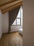 Bedroom interior detail of a mountain house. It`s snowing outside and the ceiling and floor are smooth