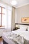 Bedroom interior in light and sand tones, bed and window