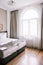 Bedroom interior in light and sand tones, bed and window