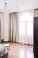 Bedroom interior in light and sand tones, bed and window