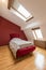 Bedroom interior in luxury red loft, attic, apartment with roof