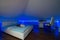 Bedroom in luxury loft apartment - shot in low light to highlight the atmosphere of blue led lights