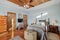 Bedroom in pastel colors with wooden doors with a vintage themed bed and a cross sign