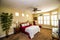 Bedroom With Queen Anne Chair & Bed With Brass headboard