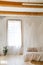 Bedroom in soft light colors with a wooden floor.