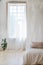 Bedroom in soft light colors with a wooden floor.