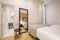 Bedroom with two beds and bathroom en suite, large full-length mirror