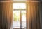 Bedroom window in the morning / sunlight through in room open curtains with balcony