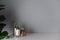 Bedroom working corner decorated with copper vase  with artificial plant inside and white candle in glass on cream spray-painted w