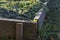 Beds made of boards for growing vegetables, winter garlic and onions, covered with coniferous branches before winter frosts