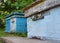 Bee Hives: Beekeeping. Swarm of honeybees coming and going around blue beehives in a bee farm.