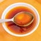 Bee honey rawhoney sweet food natural sweetener ingredient floral nectar spoon and a bowl closeup image photo