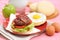 Beef bacon burger with eggs and vegetables for breakfast