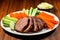 beef brisket slices paired with julienned carrots and celery