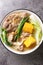 Beef Bulalo is a popular Filipino beef soup with vegetables such as Napa cabbage, green onion, bok choy and corn closeup in the