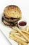 Beef burger with french fries platter on white table