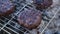 Beef burgers cutlets are roasting on the charcoal barbecue grill