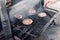 Beef Burgers And Spatula On The Hot Flaming BBQ Charcoal Grill, Close-up