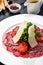 Beef Carpaccio with Arugula, Parmesan and Tomato Confiture.