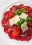 Beef Carpaccio with Arugula, Parmesan and Tomato Confiture.