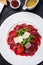 Beef Carpaccio with Arugula, Parmesan and Tomato Confiture.