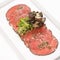 Beef carpaccio with mushrooms.