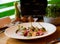 Beef carpaccio on white plate with mustard parmesan