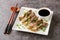 Beef Enoki Rolls are tender, juicy appetiser made from tasty enoki mushrooms wrapped in thinly sliced beef close-up in a plate.