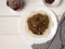 Beef goulash-delicious goulash in a white plate on a wooden white table. Filipino cuisine-Adobo beef.