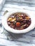 Beef goulash with mushrooms and vegetables. Bright wooden background