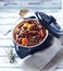 Beef goulash with mushrooms and vegetables. Bright wooden background