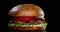 Beef juicy burger on the black background, 4k footage close up shot.