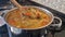 Beef lentil soup is being cooked on the stove, the cook is cooking the soup.