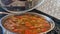 Beef lentil soup is being cooked on the stove, the cook is cooking the soup.