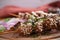 Beef liver on skewers with sesame seeds on wooden tray. Liver Kebab, kabob - image.