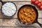 Beef Madras traditional slow cook Indian spicy chili lamb meat food with rice and tomatoes