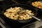 Beef meat with mushrooms fried in a pan, close-up, background, slow motion, kitchen