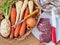 Beef meat on plate and root vegetables in basket. Ingredients for beef broth cooking.