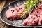 Beef meeat Rib-Eye steak wit rosemary salt and pepper on black plate