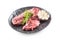 Beef meeat Rib-Eye steak wit rosemary salt and pepper in black plate isolated on white