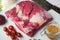 Beef navel, raw beef brisket meat,with ingredients for smoking  making  barbecue, pastrami, cure, on white stone  background