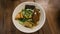 Beef noodles chili sauce served in a bowl on table top view of taiwanese food. Soup beef noodle in a bowl on wooden table. Chinese