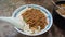 Beef noodles chili sauce served in a bowl on table top view of taiwanese food. Soup beef noodle in a bowl on wooden table. Chinese