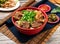 beef noodles with green onion and chili sauce served in a bowl isolated on table top view of taiwanese food