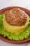 Beef and pork patty with smashed potato and lettuce.