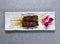 Beef satay sticks served in dish isolated on grey background top view of hong kong food
