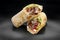 Beef shawarma on a dark background. Shawarma with beef in pita bread