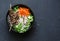 Beef skewers, rice vermicelli, pickled vegetables salad carrots, cucumbers, radishes, herbs on dark background, top view. Free spa